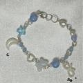 beaded charm bracelet butterfly star and moon charms with blue pearl.