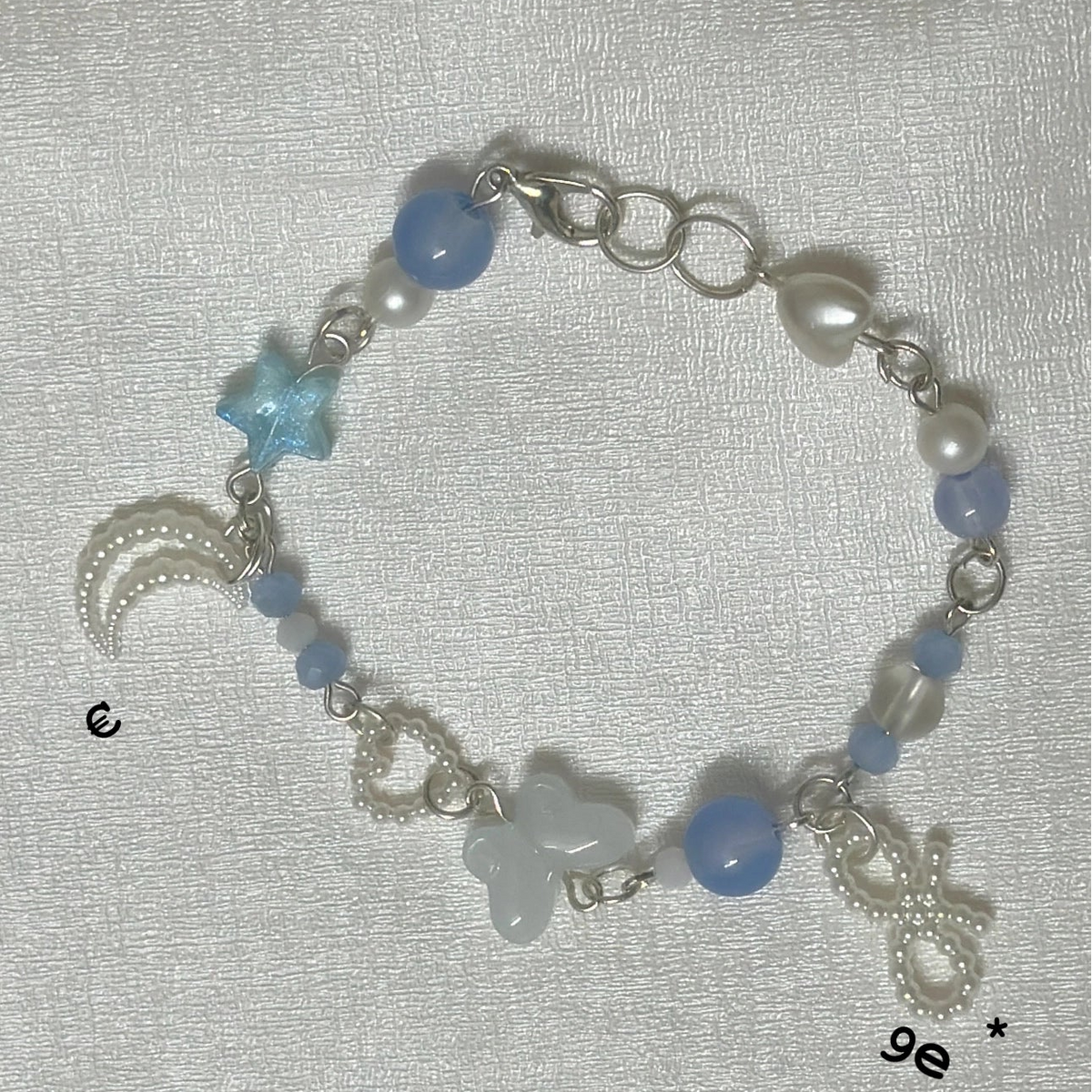 beaded charm bracelet butterfly star and moon charms with blue pearl.