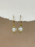Handmade white pearl drop earrings with gold-tone hooks.